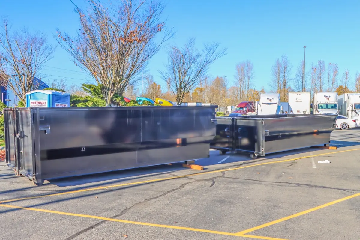 Professional dumpster rental service with roll-off container on residential driveway in Fortuna Foothills